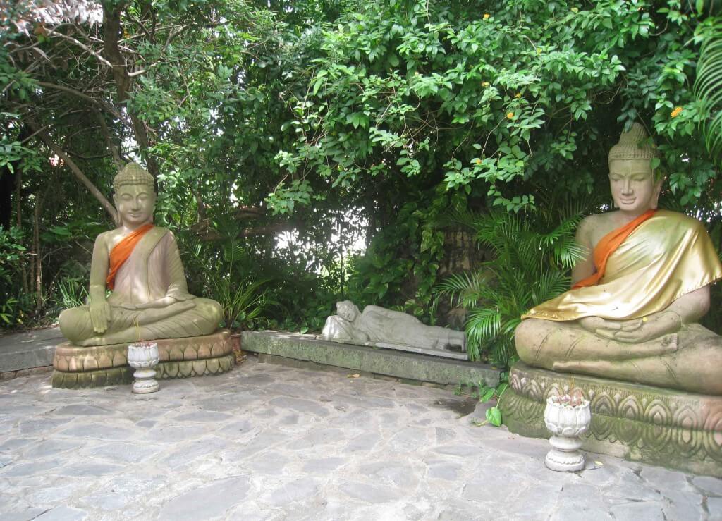 Smiling Buddhas along the pathway. Royal Palace,Emerald Buddha,Silver Pagoda