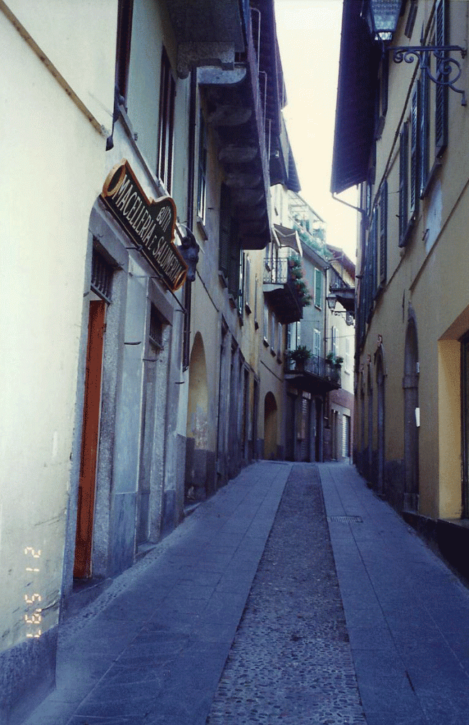 Lombardy-Bellagio--narrow streets carry one vehicle only.Pedestrians beg a doorway.