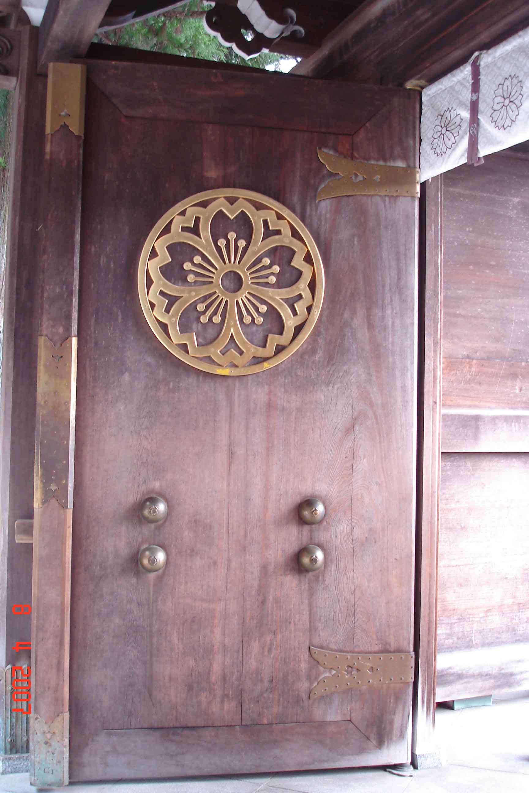 Burnished timber entrance Door to interior of Sakurayama Hachiman Shrine