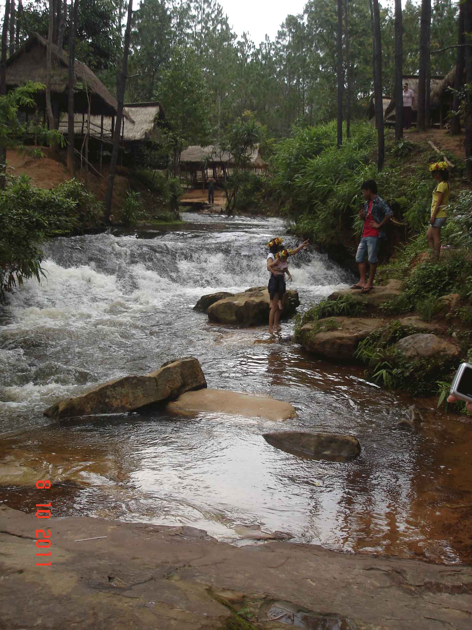 Khmer family enjoying the waterfall and running stream