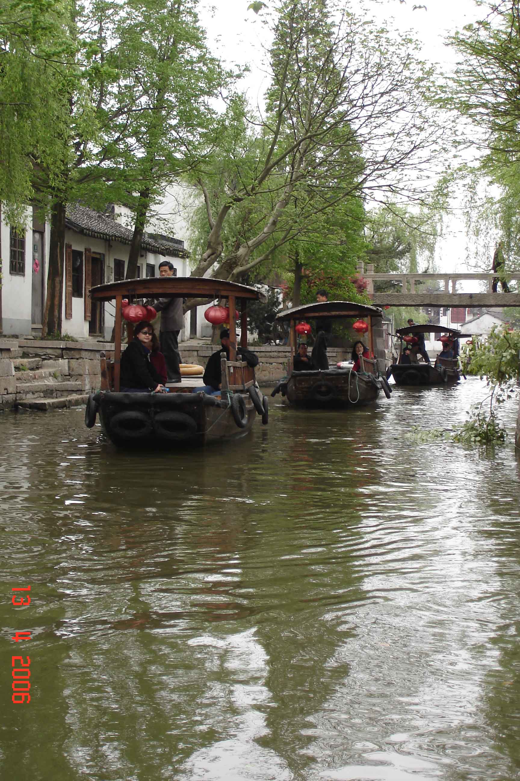 Tourists enjoy a canal boat ride through the ancient water town Zhujiajiao